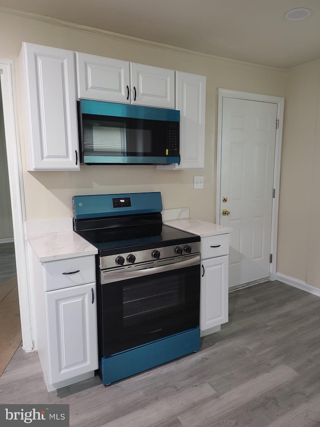 501 Tunstall Ave, Blackstone, VA 23824 - kitchen featuring stainless steel appliances, white cabinetry, and light wood-style flooring