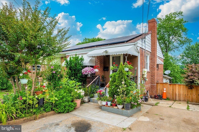 6612 Stockton Ln, Hyattsville, MD 20784 - view of front of home featuring solar panels, a chimney, and brick siding
