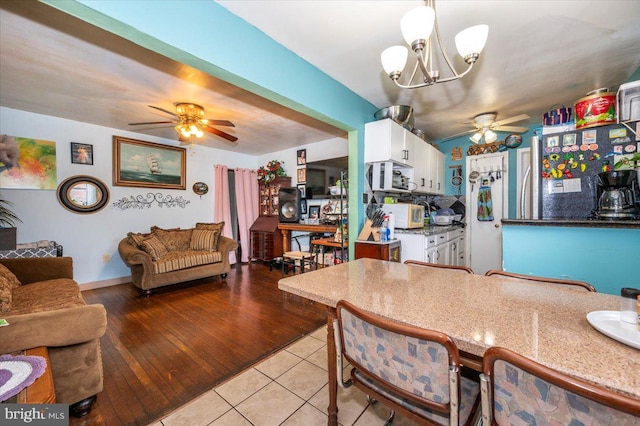 6612 Stockton Ln, Hyattsville, MD 20784 - dining area with a ceiling fan, light tile patterned flooring, and a chandelier