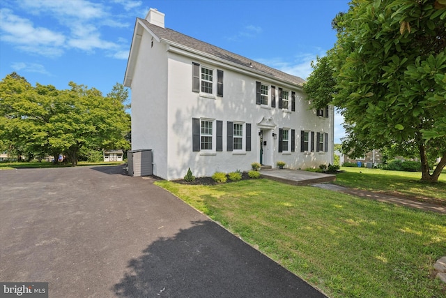 1410 Butler Pike, Conshohocken, PA 19428 - colonial house with stucco siding, a chimney, and a front yard