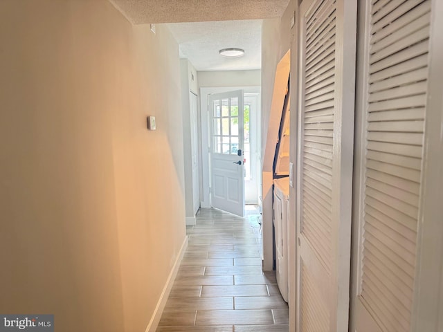 10105 Irongate Way, Manassas, VA 20109 - hall with a textured ceiling, wood finished floors, and washer / clothes dryer