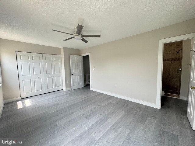 10105 Irongate Way, Manassas, VA 20109 - unfurnished bedroom with wood finished floors, a closet, a textured ceiling, and ceiling fan
