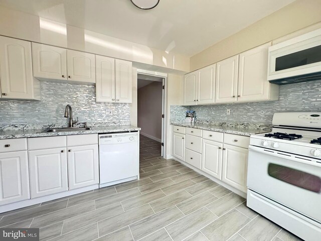 10105 Irongate Way, Manassas, VA 20109 - kitchen with white appliances, white cabinetry, backsplash, and light stone countertops