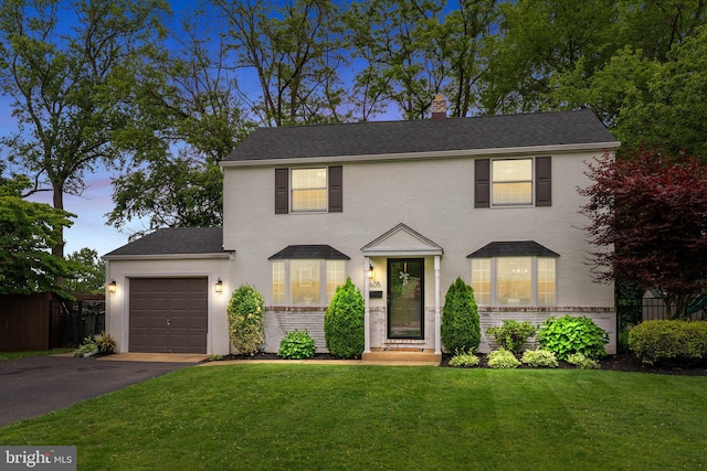 605 Lakevue Dr, Willow Grove, PA 19090 - view of front facade with an attached garage, asphalt driveway, brick siding, a shingled roof, and stucco siding