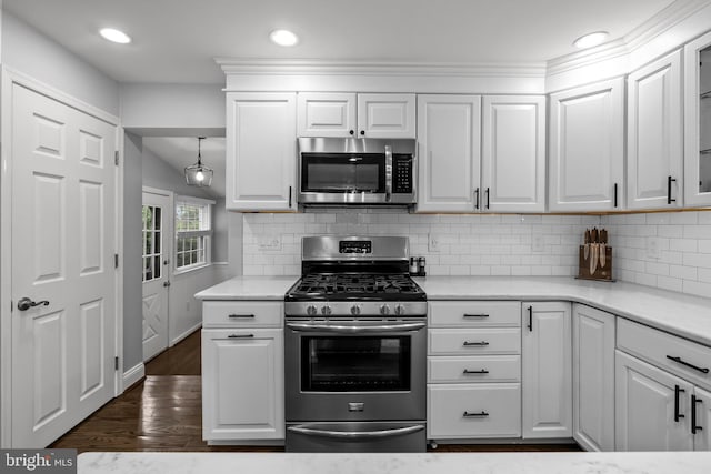 605 Lakevue Dr, Willow Grove, PA 19090 - kitchen featuring appliances with stainless steel finishes, white cabinets, tasteful backsplash, dark wood-style flooring, and recessed lighting