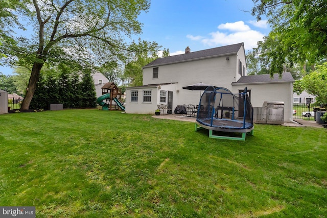 605 Lakevue Dr, Willow Grove, PA 19090 - rear view of property with a trampoline, stucco siding, a playground, a patio, and a chimney