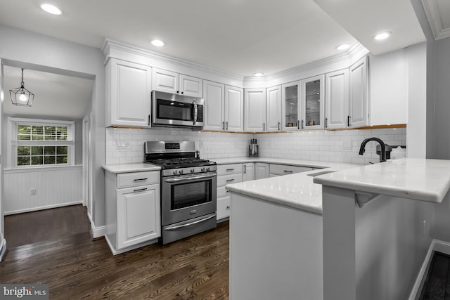 605 Lakevue Dr, Willow Grove, PA 19090 - kitchen with stainless steel appliances, a peninsula, dark wood finished floors, white cabinetry, and recessed lighting