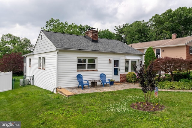 7930 Rolling View Ave, Baltimore, MD 21236 - rear view of property featuring a chimney, a patio, and roof with shingles