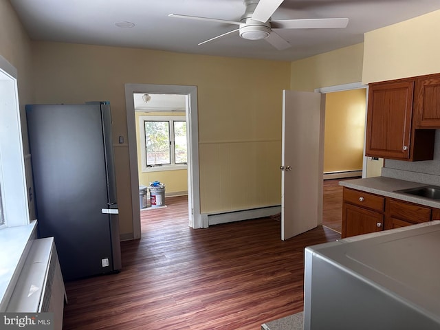 524 W Orvilla Rd, Hatfield, PA 19440 - kitchen featuring baseboard heating, freestanding refrigerator, a ceiling fan, dark wood-type flooring, and brown cabinetry