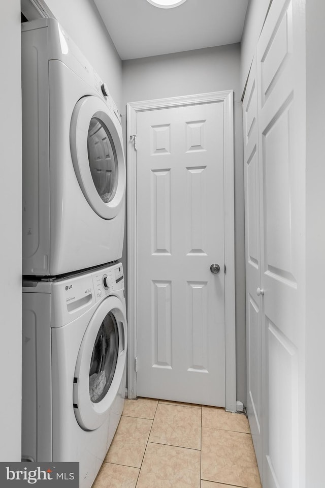 196 Saint Johns Sq, Sterling, VA 20164 - washroom featuring stacked washer and clothes dryer and light tile patterned floors