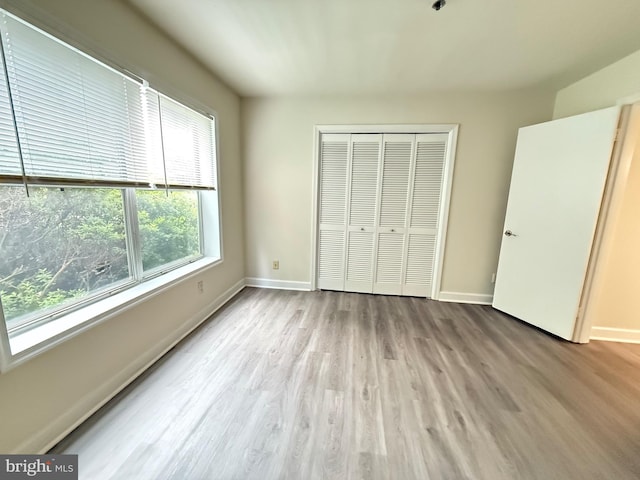 3179 Summit Square Dr Unit 2-B5, Oakton, VA 22124 - unfurnished bedroom featuring a closet and wood finished floors