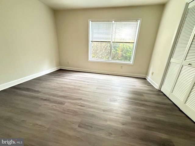 3179 Summit Square Dr Unit 2-B5, Oakton, VA 22124 - unfurnished bedroom with a closet and dark wood-style flooring