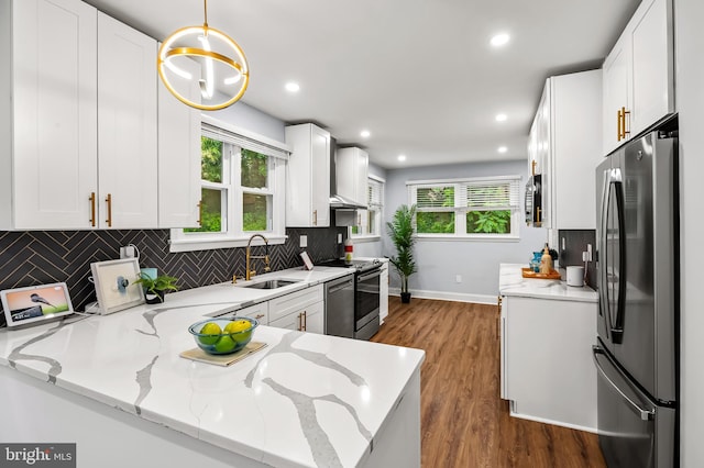 904 Stevenson Ln, Towson, MD 21286 - kitchen featuring stainless steel appliances, light stone counters, backsplash, dark wood finished floors, and white cabinets