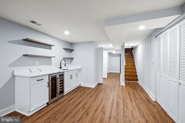 904 Stevenson Ln, Towson, MD 21286 - indoor wet bar featuring wine cooler, light wood-style flooring, stairway, and recessed lighting