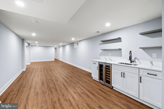 904 Stevenson Ln, Towson, MD 21286 - indoor wet bar with wine cooler, light wood-type flooring, and recessed lighting