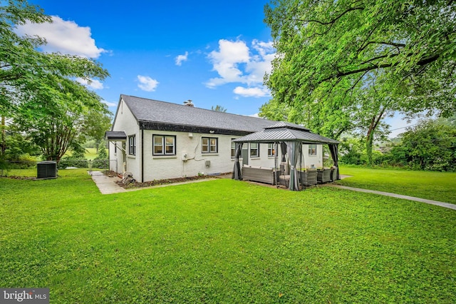 904 Stevenson Ln, Towson, MD 21286 - back of house featuring a gazebo, a lawn, roof with shingles, brick siding, and a chimney