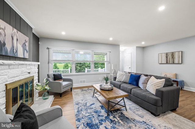 904 Stevenson Ln, Towson, MD 21286 - living room with light wood-type flooring, recessed lighting, and a stone fireplace