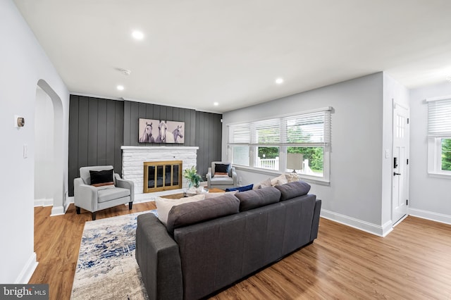 904 Stevenson Ln, Towson, MD 21286 - living area featuring arched walkways, wood finished floors, a fireplace, and recessed lighting
