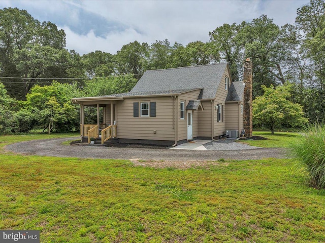 69 Mary Elmer Dr, Bridgeton, NJ 08302 - rear view of house featuring a chimney, a lawn, a shingled roof, and a patio area