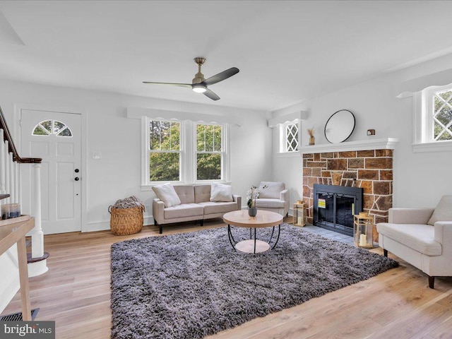 69 Mary Elmer Dr, Bridgeton, NJ 08302 - living room with stairway, a ceiling fan, wood finished floors, and a fireplace