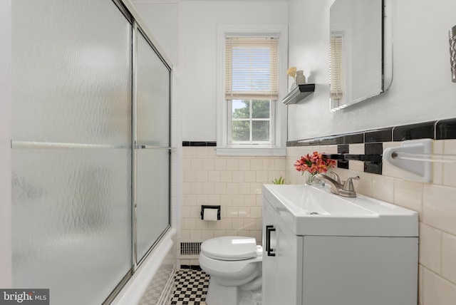 1906 Glen Keith Blvd, Towson, MD 21286 - full bathroom featuring tile walls, vanity, wainscoting, and shower / bath combination with glass door