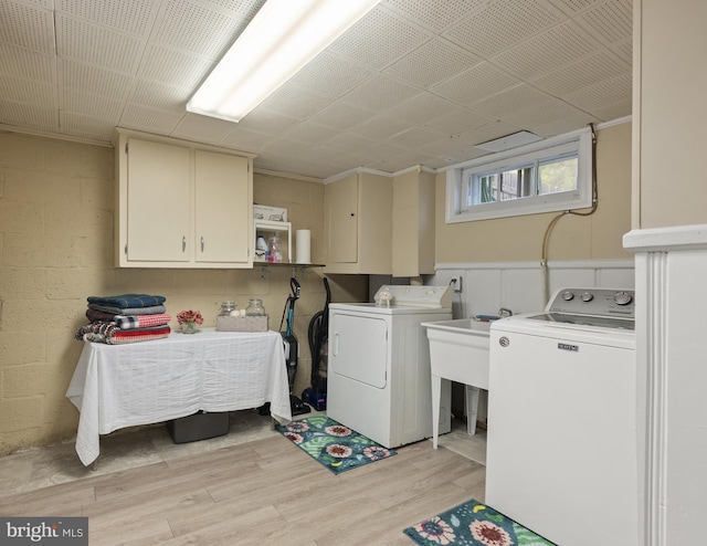 1906 Glen Keith Blvd, Towson, MD 21286 - laundry area featuring cabinet space, washing machine and dryer, and light wood-style flooring