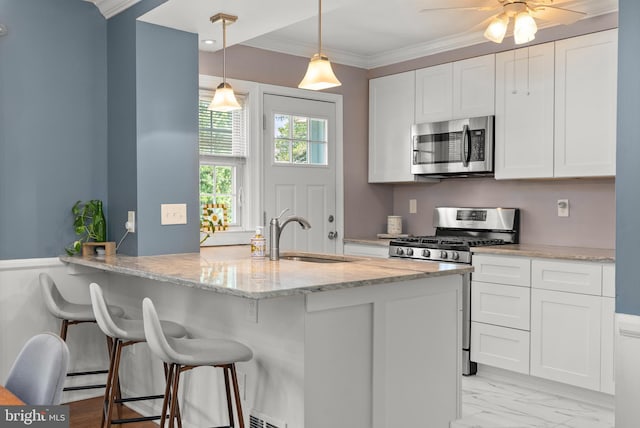 1906 Glen Keith Blvd, Towson, MD 21286 - kitchen with stainless steel appliances, white cabinets, light stone countertops, a kitchen breakfast bar, and crown molding