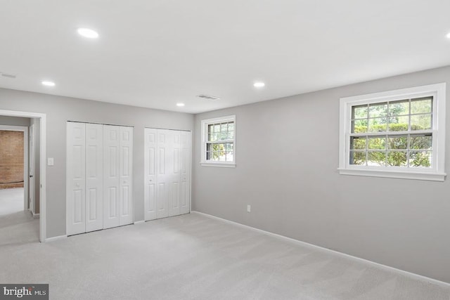 1121 Collingwood Rd, Alexandria, VA 22308 - unfurnished bedroom with multiple closets, carpet, and recessed lighting