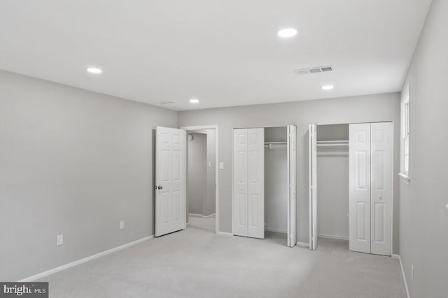 1121 Collingwood Rd, Alexandria, VA 22308 - unfurnished bedroom featuring multiple closets, light colored carpet, and recessed lighting