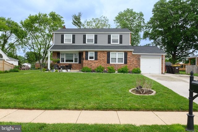 744 Caley Rd, King Of Prussia, PA 19406 - view of front facade featuring brick siding, driveway, a garage, and a front yard