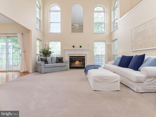 848 Sunny Chapel Rd, Odenton, MD 21113 - living room with a high ceiling, carpet floors, ceiling fan, and a glass covered fireplace