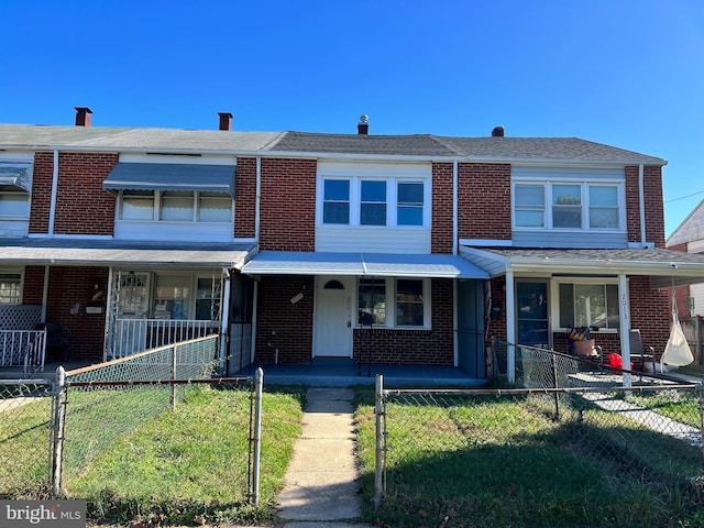 2011 Larkhall, Baltimore, MD 21222 - townhome / multi-family property featuring a fenced front yard, covered porch, and brick siding