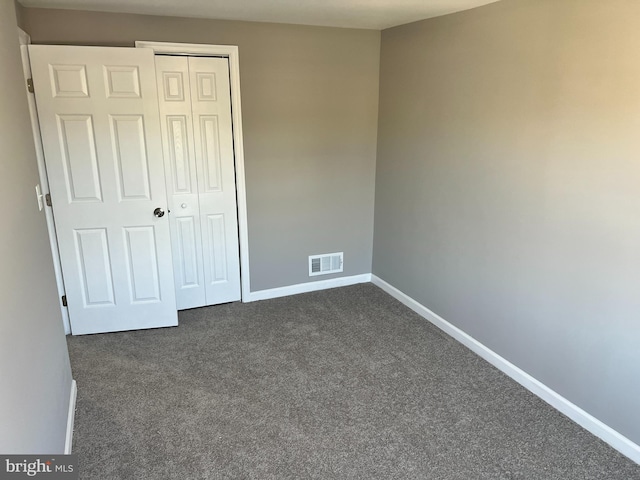 2011 Larkhall, Baltimore, MD 21222 - unfurnished bedroom featuring dark colored carpet and a closet