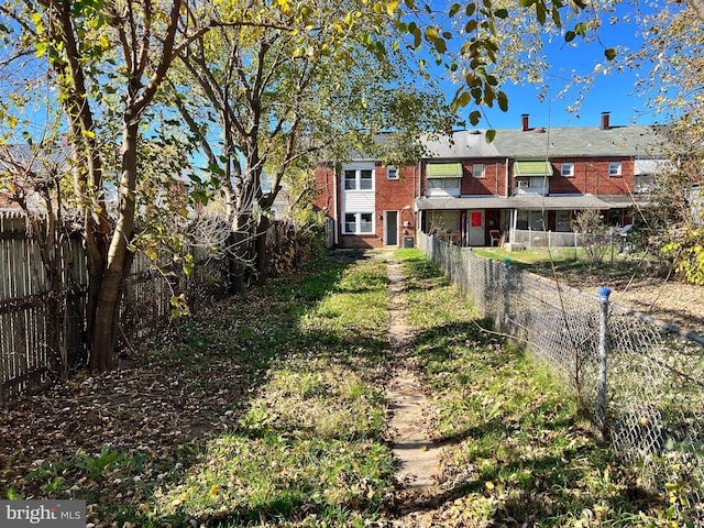 2011 Larkhall, Baltimore, MD 21222 - rear view of house with a fenced backyard and brick siding