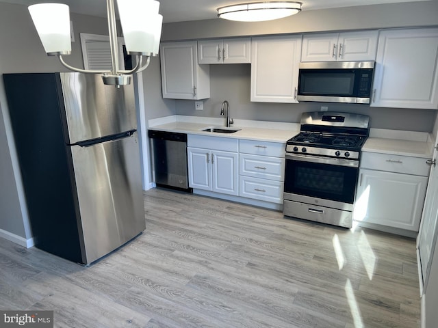 2011 Larkhall, Baltimore, MD 21222 - kitchen featuring appliances with stainless steel finishes, light countertops, and light wood-style floors