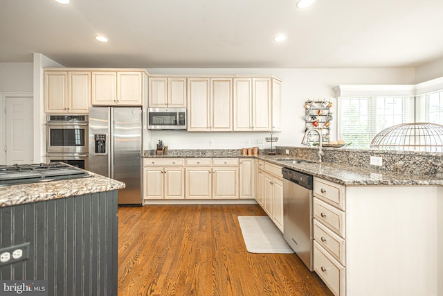 405 Hoffman Rd, Harleysville, PA 19438 - kitchen featuring stainless steel appliances, a peninsula, dark wood-style floors, recessed lighting, and light stone counters