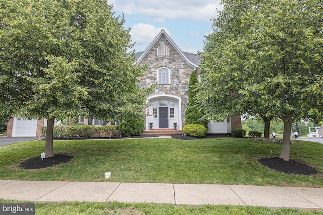 405 Hoffman Rd, Harleysville, PA 19438 - view of front of property with a front yard, stone siding, a garage, driveway, and brick siding