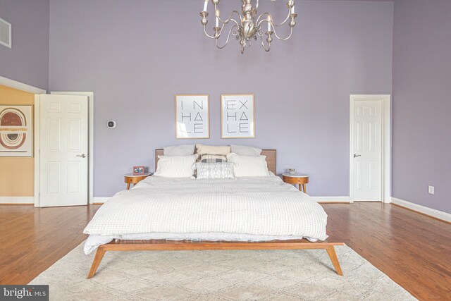 405 Hoffman Rd, Harleysville, PA 19438 - bedroom with a high ceiling, a chandelier, and wood finished floors