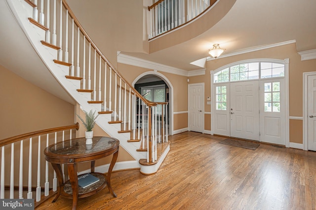 405 Hoffman Rd, Harleysville, PA 19438 - foyer featuring arched walkways, wood finished floors, ornamental molding, stairway, and a high ceiling