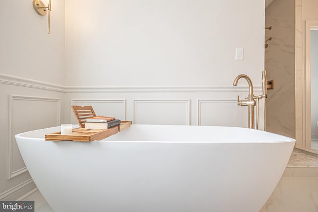 405 Hoffman Rd, Harleysville, PA 19438 - full bathroom featuring a stall shower, a decorative wall, a freestanding tub, a wainscoted wall, and marble finish flooring