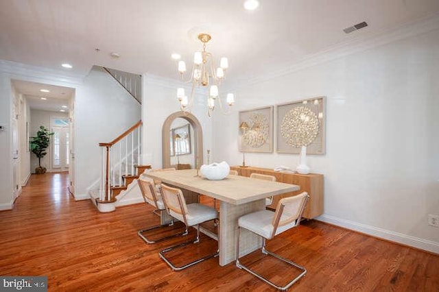 409 S Henry St, Alexandria, VA 22314 - dining area with stairway, ornamental molding, wood finished floors, a chandelier, and arched walkways