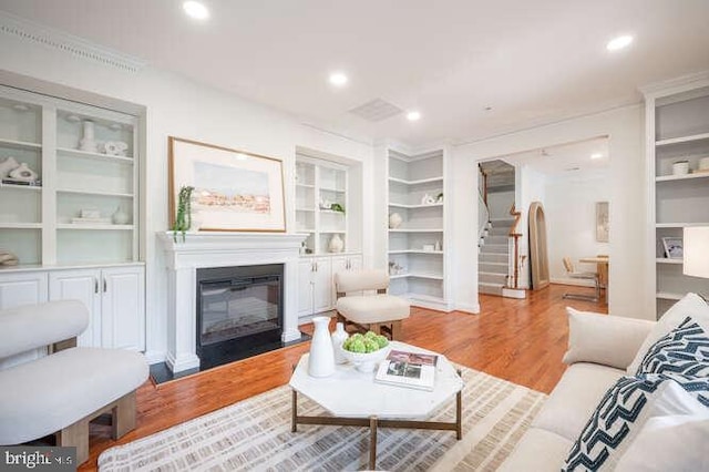 409 S Henry St, Alexandria, VA 22314 - living room with a glass covered fireplace, stairway, wood finished floors, built in features, and recessed lighting
