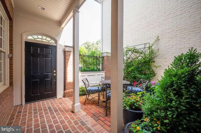 409 S Henry St, Alexandria, VA 22314 - entryway featuring brick floors and brick wall