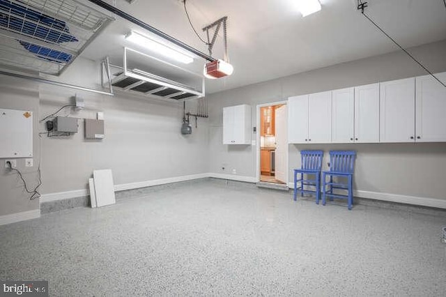 409 S Henry St, Alexandria, VA 22314 - garage with baseboards and a garage door opener