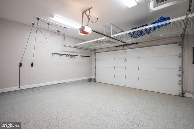 409 S Henry St, Alexandria, VA 22314 - garage featuring a garage door opener and baseboards