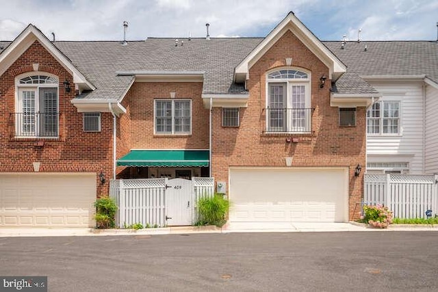 409 S Henry St, Alexandria, VA 22314 - view of front of property featuring a garage, brick siding, and a gate