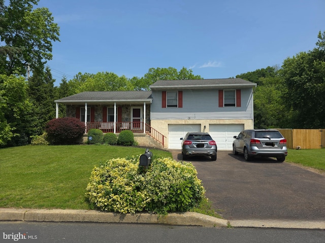 100 Constitution Ave, Reading, PA 19606 - split level home with a porch, asphalt driveway, and an attached garage