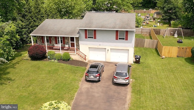 100 Constitution Ave, Reading, PA 19606 - tri-level home with a porch, asphalt driveway, roof with shingles, and an attached garage
