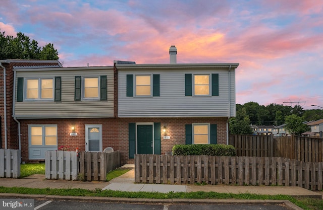 2801 Banks Ct, Dumfries, VA 22026 - view of front of property with uncovered parking, a chimney, and brick siding