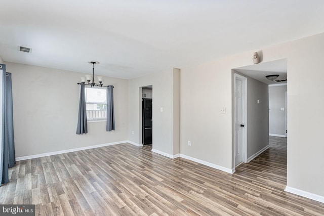 2801 Banks Ct, Dumfries, VA 22026 - unfurnished room featuring light wood-style flooring and a chandelier